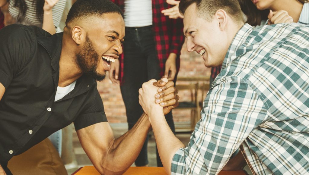 cheerful friends having fun arm wrestling 2025 03 18 17 03 25 utc 1 scaled.jpg